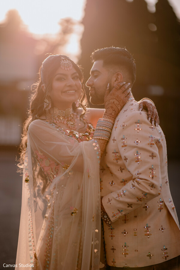 sunset couple shoot,bridal glow,intimate embrace,romantic moment,ivory bridal outfit,post-wedding shoot,sunlight portrait,candid smile,close couple shot,evening magic
