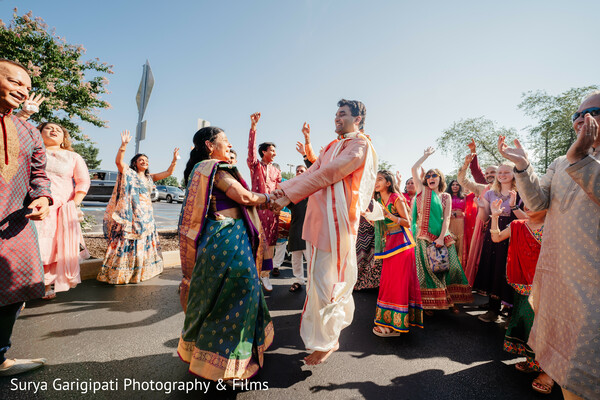 baraat celebration,outdoor wedding festivities,dancing crowd,vibrant wedding attire,same-sex indian wedding,joyful procession,traditional wedding customs,cultural celebration,festive energy,community love