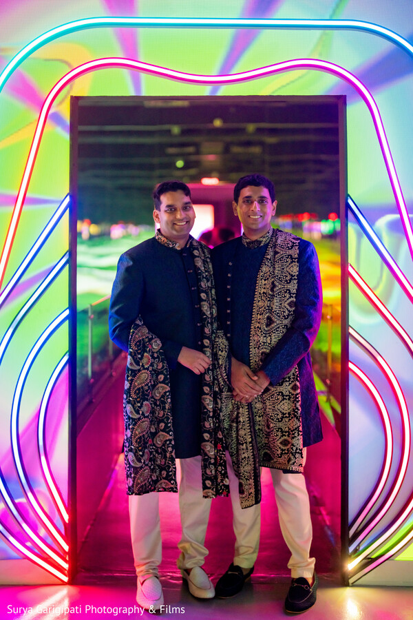 neon wedding backdrop,colorful couple photo,vibrant wedding photography,traditional meets modern,indian groom style,joyful love shot,creative wedding portrait,glowing love,stylish wedding attire