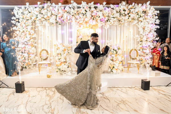 marble floor wedding photo,couple celebration,glamorous reception scene,elegant wedding backdrop,joyful wedding moment