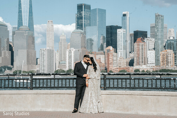 city skyline backdrop,intimate couple moment,silver gown bride,black groom suit,urban wedding photo,romantic couple pose,stylish wedding photography,outdoor wedding setting,destination city wedding,elegant love shot