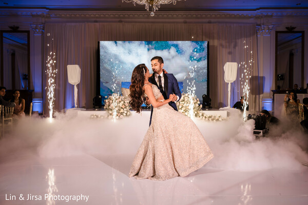 first dance,wedding fog effect,romantic reception,sparkler backdrop,luxury wedding decor,dreamy dance floor,bride and groom dance,reception highlights,south asian reception,cinematic romance