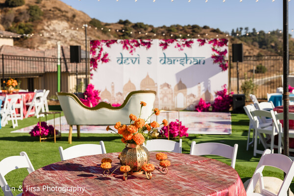 wedding decor,outdoor reception,vibrant florals,south asian wedding design,lounge setup,daytime celebration,fuchsia wedding,orange wedding details,wedding signage,stylish outdoor event