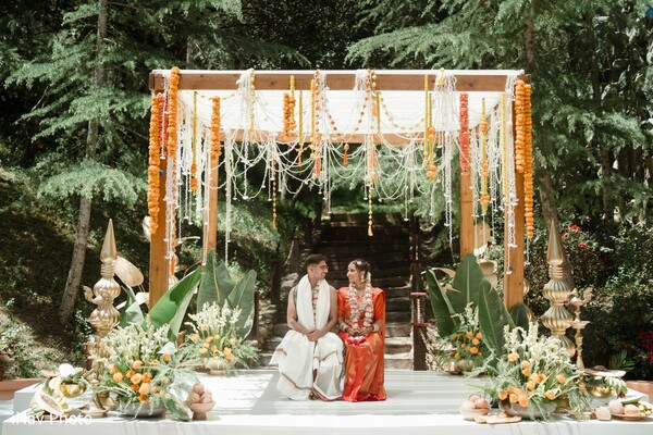 mandap decor,marigold wedding,south asian ceremony,bride and groom altar,traditional vows,cultural wedding design,sacred wedding rituals,floral mandap inspiration,hindu wedding decor,greenery and marigold theme