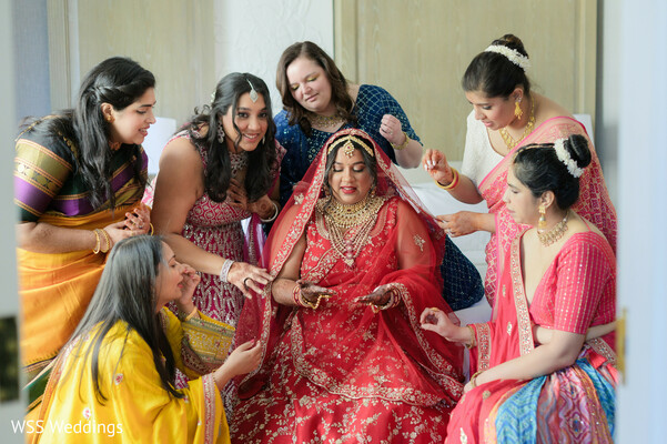 wedding ceremony embrace,south asian cultural rituals,family wedding blessings,red bridal lehenga,ivory groom sherwani,sacred wedding traditions,joyful cultural wedding,bride groom hug,indian wedding love moment,family wedding celebration