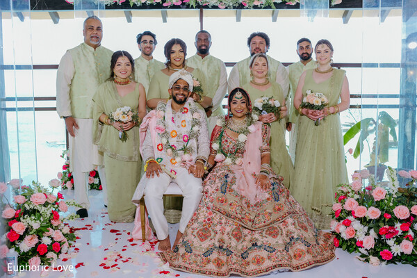 wedding party,group photo,coordinated outfits,family wedding portrait,joyful wedding shot,bridesmaids and groomsmen,indoor wedding,south asian wedding,ceremony group,wedding memories