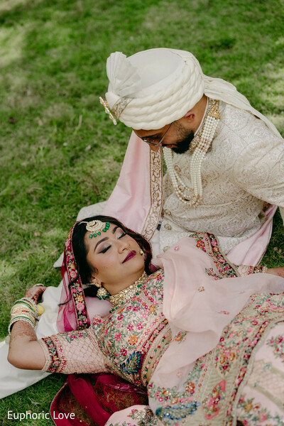 romantic couple,outdoor wedding portrait,bride and groom love,tender moment,pink lehenga,south asian groom,wedding romance,natural wedding shot,love in detail,candid couple photo