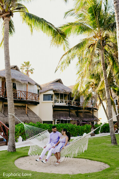hammock couple,tropical wedding,candid bride and groom,resort romance,outdoor love,palm tree background,destination wedding,intimate portrait,relaxed wedding photo,tropical love