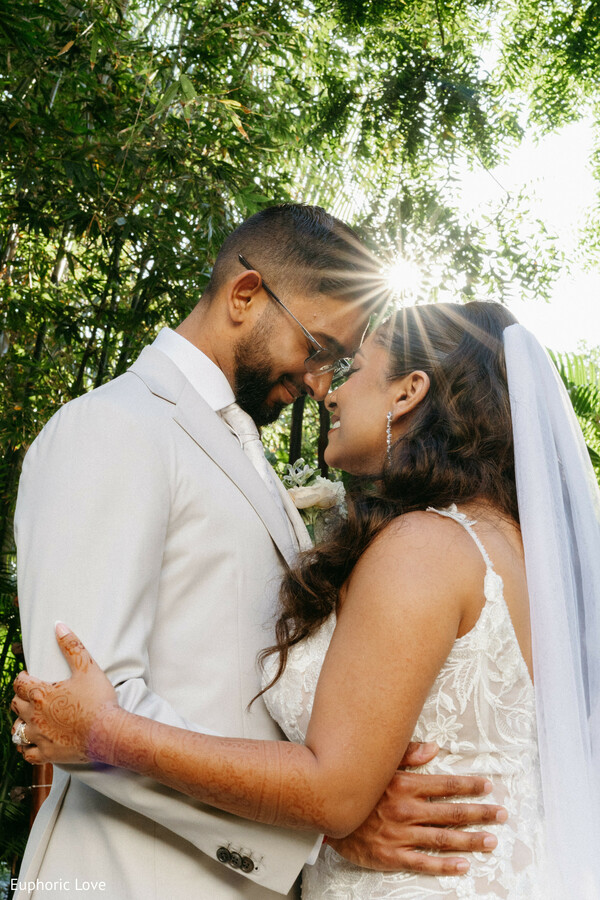 bride and groom love,white wedding dress,romantic couple portrait,south asian wedding,forehead touch,outdoor wedding photo,wedding romance,natural light wedding,emotional wedding shot,elegant couple photo