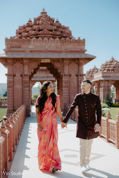 wedding walk,just married,couple goals,indian newlyweds,unity captured,temple background,radiant love,hand in hand,traditional wedding,joyful exit