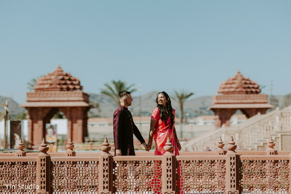 temple wedding,groomsmen,indian groom,sherwani style,traditional ceremony,cultural heritage,outdoor temple,wedding guests,festive attire,grand architecture
