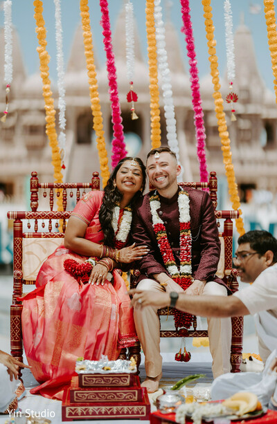 mandap ceremony,indian couple,hindu wedding,sacred vows,bride and groom,traditional rituals,joyful couple,cultural celebration,love captured,vibrant decor