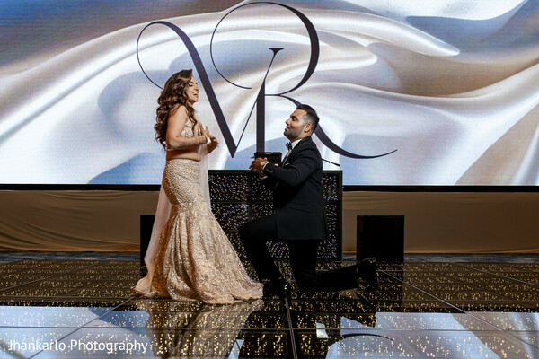 glamorous couple,reception outfit,black tuxedo,glittering gown,elegant pose,indoor stage,wedding reception,stylish bride,cancun wedding reception,modern elegance