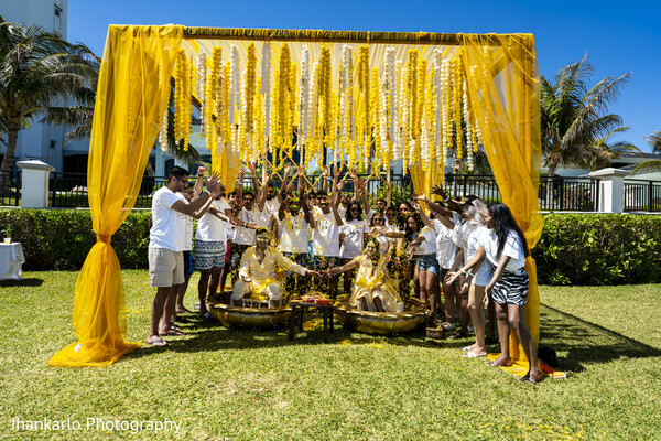 marigold canopy,haldi ceremony,mehndi event,indian wedding traditions,colorful decor,yellow theme,outdoor ceremony,wedding guests,cultural celebration,festive setup
