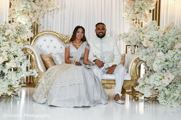 wedding stage decor,floral reception,pastel wedding theme,indian couple,bridal lehenga,reception seating,romantic wedding stage,luxurious wedding,couple portrait,elegant celebration