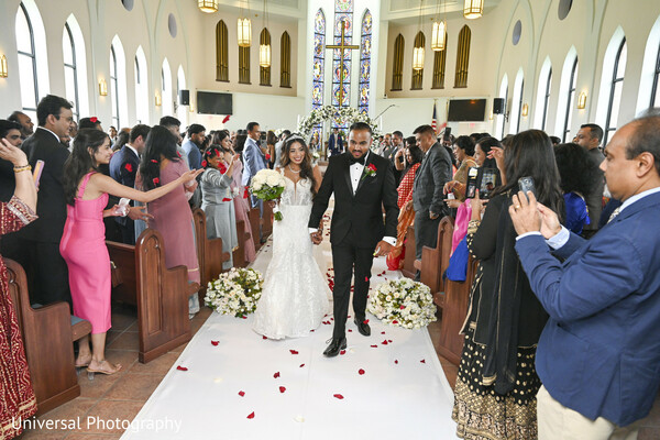church wedding,bride and groom exit,wedding aisle,guests cheering,wedding photography,classic church ceremony,timeless wedding,celebration moment,couple walking,joyful exit