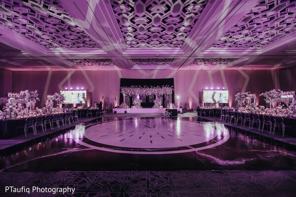 indoor garden wedding,gold sari bride,romantic couple portrait,lush wedding greenery,south asian wedding moment,enchanted forest aesthetic,tropical foliage decor,intimate couple pose,bridal hair gajra,dreamy wedding lighting