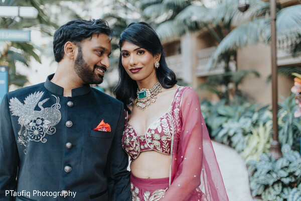 engagement couple portrait,luxury indian outfits,emerald bridal necklace,black sherwani,bridal blouse design,pre-wedding photo inspiration,mauve lehenga look,south asian wedding fashion,tropical garden wedding,statement jewelry bride
