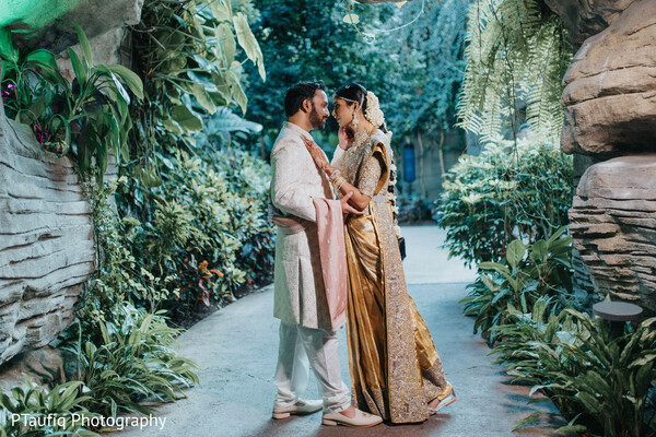 just married couple walk,golden sari bride,floral aisle wedding,romantic ceremony moment,south asian wedding couple,post-ceremony glow,wedding walk together,lush floral wedding,pink rose aisle decor,bride and groom together
