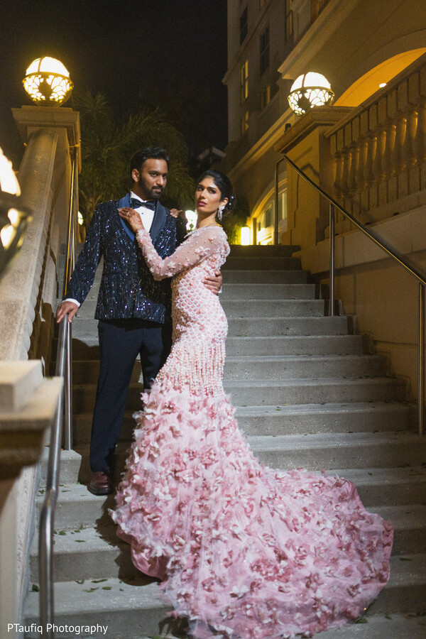 indoor garden wedding,gold sari bride,romantic couple portrait,lush wedding greenery,south asian wedding moment,enchanted forest aesthetic,tropical foliage decor,intimate couple pose,bridal hair gajra,dreamy wedding lighting