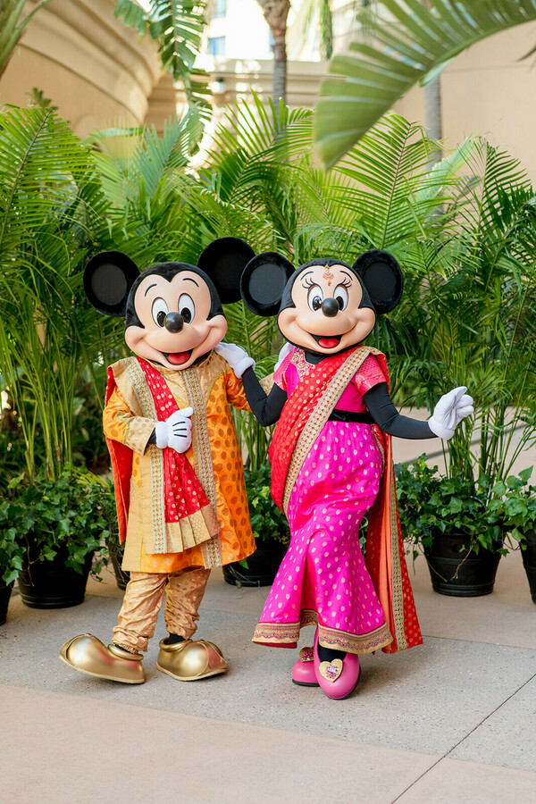 disney wedding,mickey and minnie,cultural fusion,playful wedding,indian attire,destination celebration,joyful moment,vibrant tradition,magical love,unique ceremony