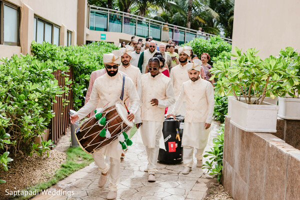 baraat procession,dhol player,indian groom,beach wedding,south asian destination wedding,tropical ceremony,cultural celebration,oceanfront portraits,wedding joy,festive march