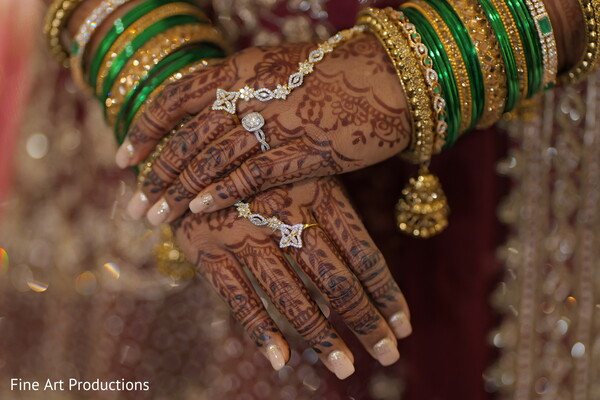bridal mehndi,green bangles,gold jewelry,hand close-up,bridal accessories,wedding details,henna art,traditional bride,intricate design,cultural beauty