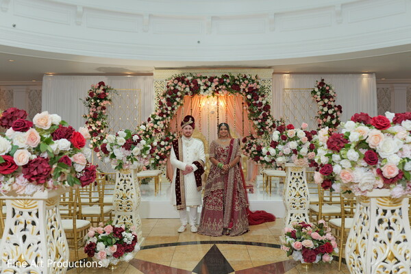 wedding ceremony,floral garlands,golden mandap chairs,indian fusion wedding,happy couple,south asian decor,blush floral wedding,traditional vows,joyful ceremony,regal wedding look
