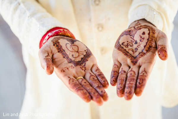 mehndi hands,groom henna,love symbols,wedding detail,cultural tradition,south asian groom,henna art,pre-ceremony ritual,heart designs,personal touch