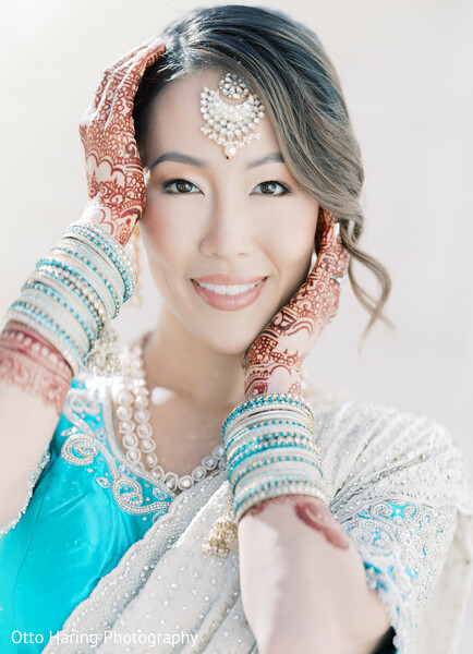 bridal portrait,turquoise jewelry,ivory sari,soft makeup,natural light,joyful bride,south asian beauty,elegant style,traditional attire,serene expression