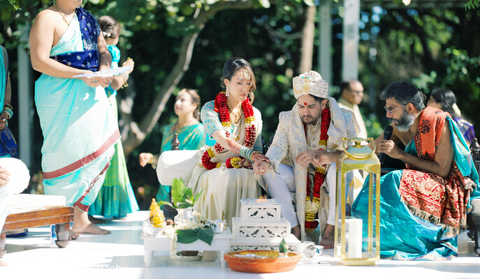 hindu wedding,agni ceremony,family moments,sacred rituals,south asian culture,outdoor ceremony,spiritual vows,joyful wedding,cultural heritage