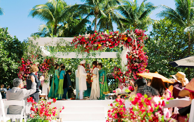 mandap decor,tropical wedding,red and pink florals,palm trees,outdoor ceremony,luxury venue,cultural celebration,south asian wedding,floral arch,elegant altar