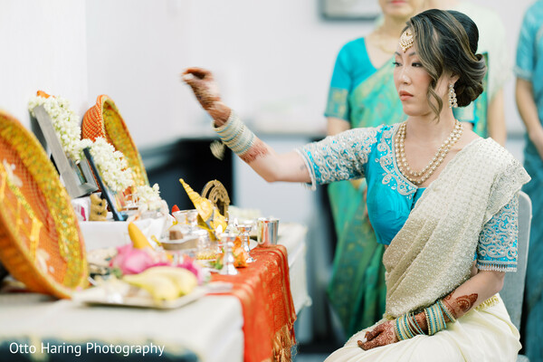 hindu ritual,wedding ceremony,offering table,cream and turquoise sari,traditional bride,south asian customs,puja ceremony,sacred moment,cultural beauty,devotion