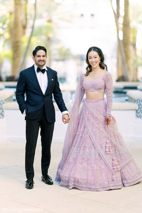 lavender lehenga,tuxedo groom,couple portrait,south asian reception,elegant fashion,evening style,newlyweds,pastel tones,outdoor venue,luxury wedding look