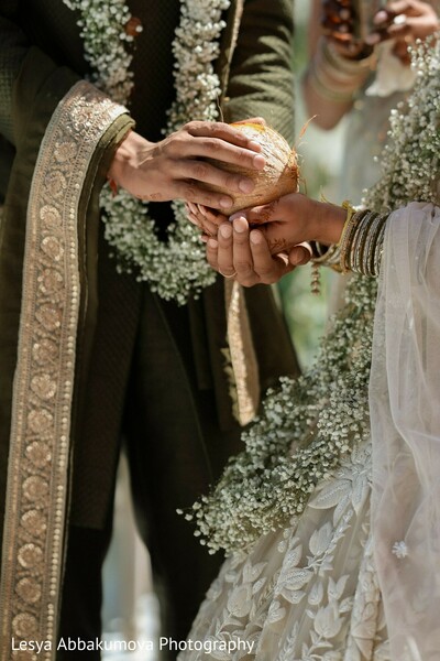 hindu wedding rituals,coconut ritual,ceremony details,symbolic moment,south asian traditions,mandap ceremonies