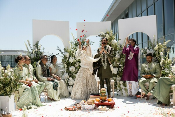 rose petal toss,south asian wedding ceremony,blessing moment,mandap scene,cultural celebration,wedding traditions