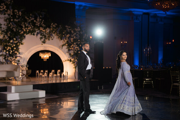 reception portraits,south asian couple,evening glamour,ballroom wedding,designer gown,tuxedo groom,luxury reception,modern desi couple,dramatic lighting,wedding fashion