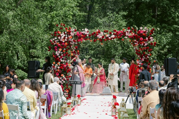 south asian wedding,mandap ceremony,hindu rituals,wedding vows,floral mandap,outdoor ceremony,indian couple traditions,desi wedding decor,blush and red florals,cultural rituals