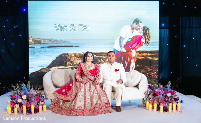 led wedding backdrop,reception stage photo,south asian couple,luxury wedding setup,candles and florals,wedding inspiration,cinematic wedding moments,indian wedding reception