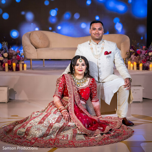 south asian bride,reception portrait,embroidered red lehenga,ivory sherwani,wedding stage decor,luxury wedding reception,bridal jewelry,indian wedding photography,couple portraits,maharani style