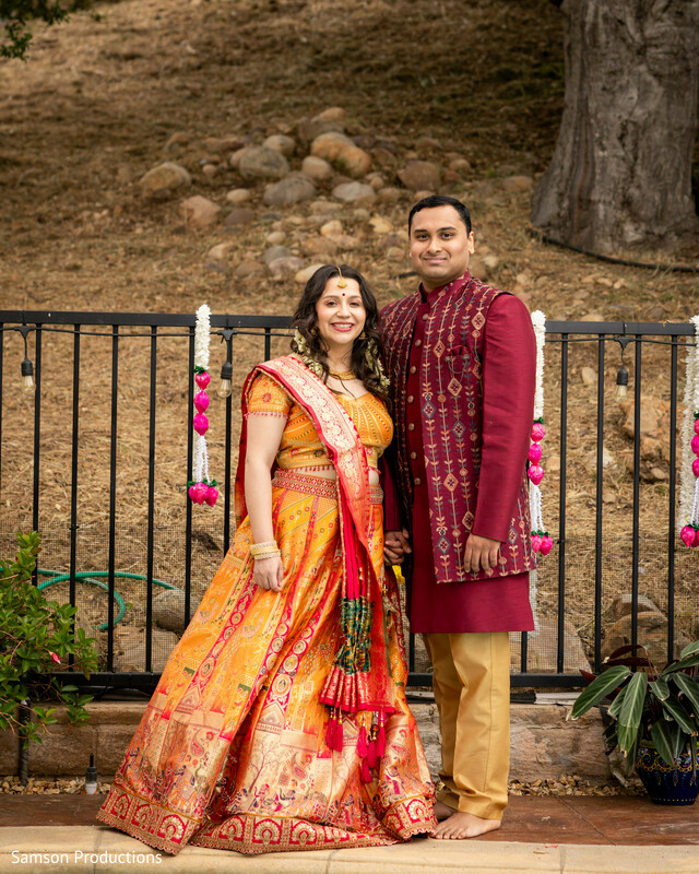 pre-wedding portrait,traditional indian outfits,marigold lehenga,maroon sherwani,outdoor wedding shoot,south asian couple,colorful wedding fashion,indian wedding style