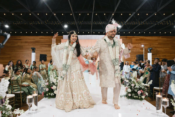 indian wedding ceremony,bride groom recessional,south asian wedding aisle,wedding celebration moment,newlyweds joy