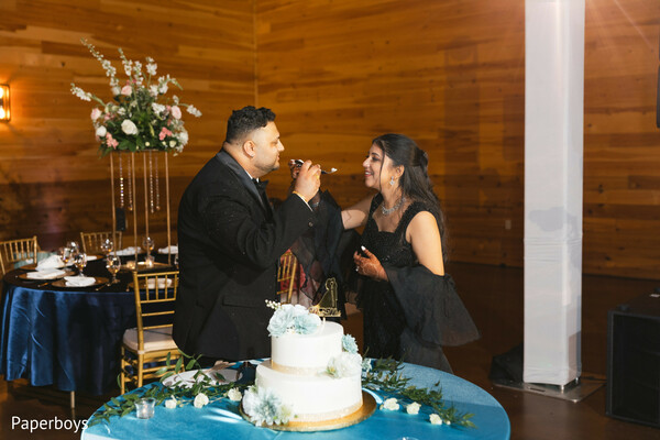 indian wedding reception,wedding cake cutting,south asian reception moments,newlywed celebration,wedding dessert moment