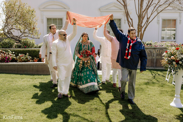 indian bridal entrance,south asian wedding ceremony,bridal lehenga,emotional wedding moments,destination wedding traditions,family wedding support,hindu wedding customs