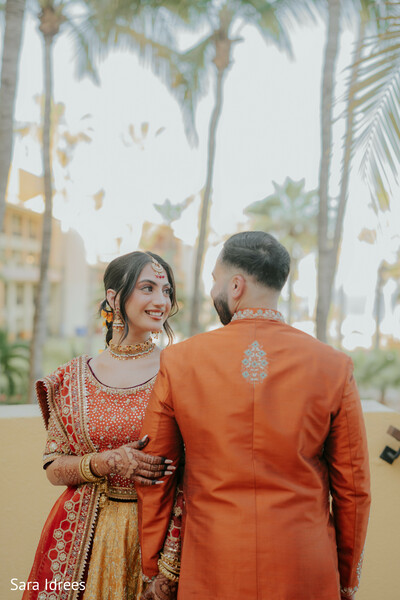bride looking back,embroidered dupatta,candid couple moment,destination wedding walk,indian bridal elegance,romantic storytelling,movement in bridal fashion,modern south asian wedding,heartfelt connection,luxury wedding portrait