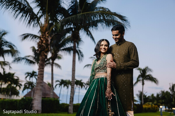south asian pre wedding,evening portraits,green lehenga,embroidered kurta,tropical engagement,mehndi details,destination romance,candid couple,palm tree backdrop,festive attire