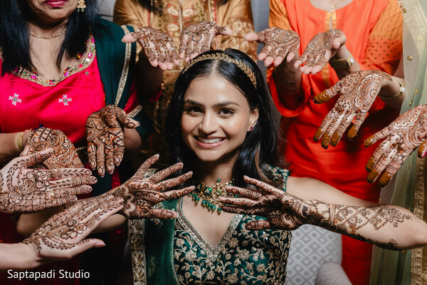 mehndi ceremony,henna celebration,south asian bride,bridal party,cultural traditions,joyful moment,intricate henna,pre wedding festivities,female bonding,wedding rituals