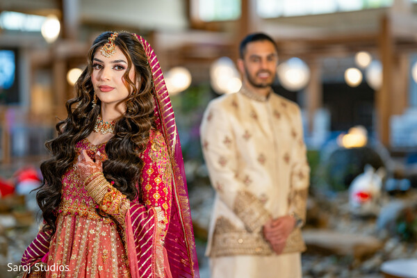 bridal portrait,lehenga details,wedding anticipation,embroidered bridal outfit,indian bride elegance,groom in sherwani,pre ceremony moment,bridal jewelry,destination wedding,romantic pause