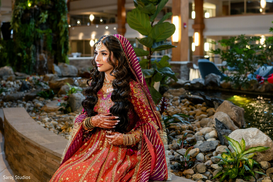 bridal portrait,indoor garden wedding,red lehenga,bridal jewelry,south asian elegance,pre ceremony calm,luxury wedding,indian bridal look,cultural wedding attire,bridal glow