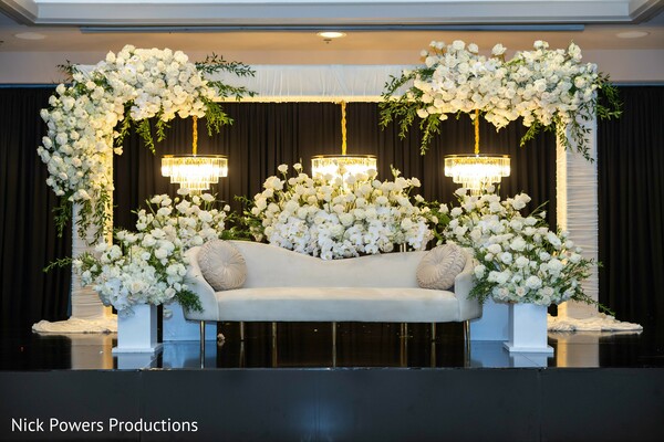 outdoor wedding ceremony setup,waterfront indian wedding,mandap aisle view,white ceremony chairs,luxury outdoor wedding,floral ceremony decor,destination indian wedding,serene wedding setting,elegant ceremony layout,romantic venue styling